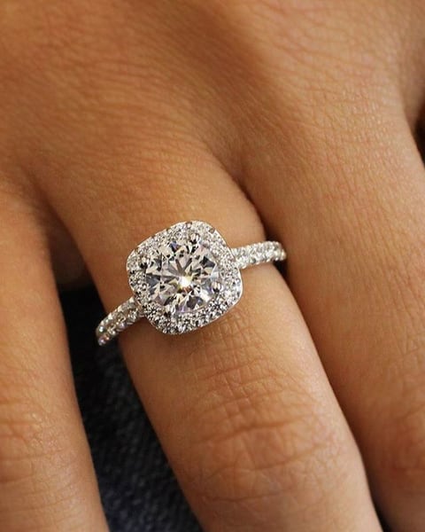 Cushion halo diamond ring worn on the hand