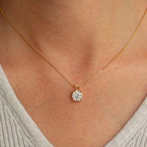 Solitaire diamond pendant worn on a fine gold chain