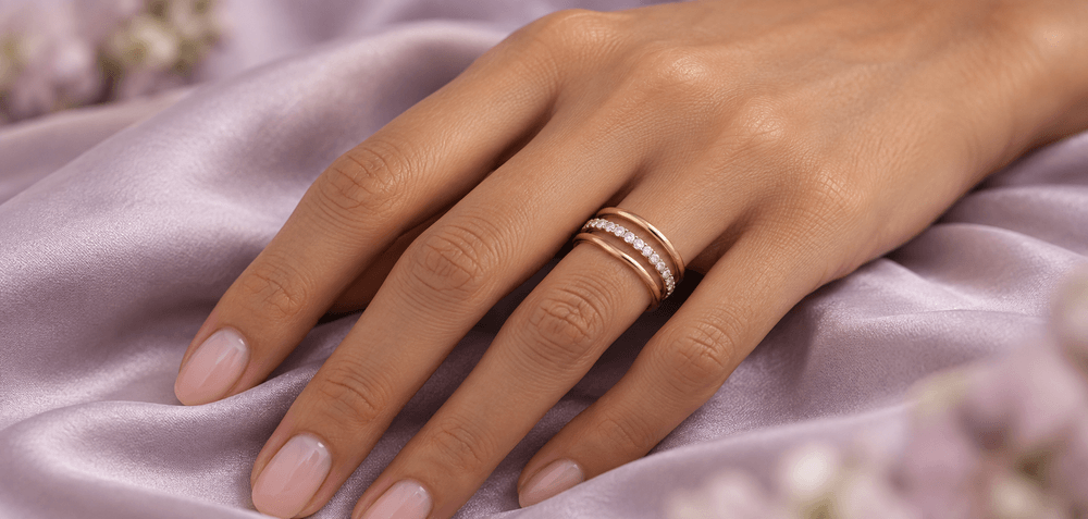 Hand wearing stacked gold and diamond rings