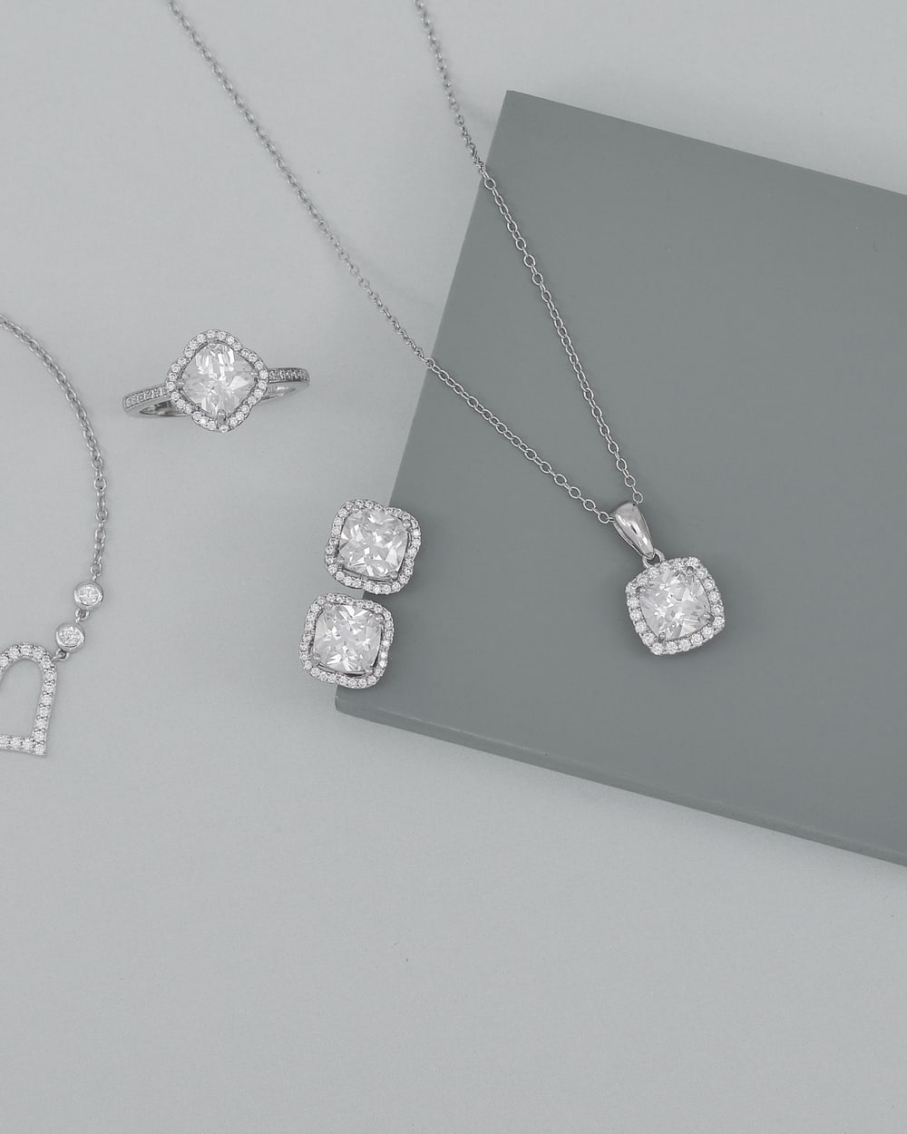Matching diamond pendant, stud earrings and ring