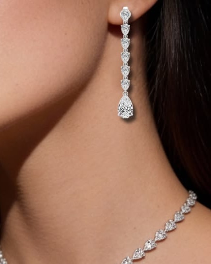 Woman wearing a long pear-cut diamond drop earring
